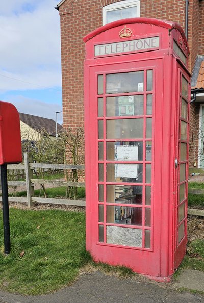 Red phone box with community library in Habrough, North East Lincolnshire